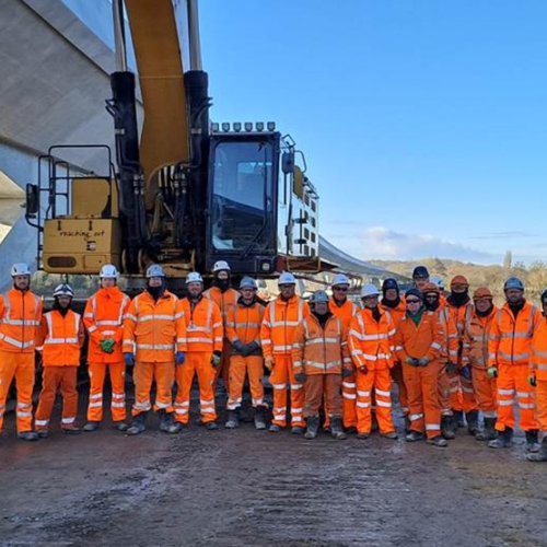 Group picture of men and women in orange hi vis workwear