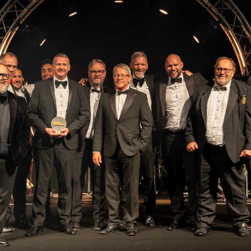 Men in suits on a stage.