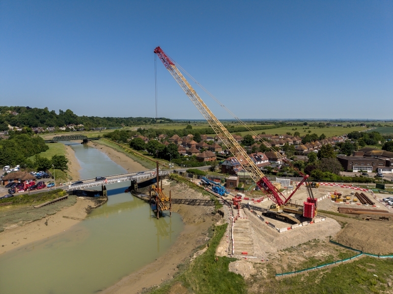 lifting crane over a river, lifting sheet piles