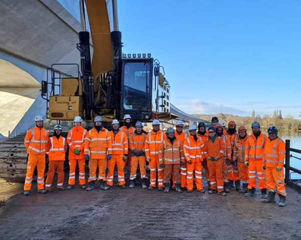 Group picture of men and women in orange hi vis workwear