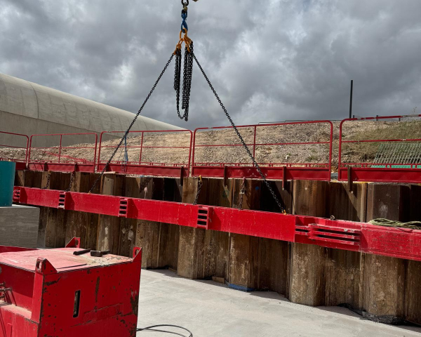 Crane lifting piles.