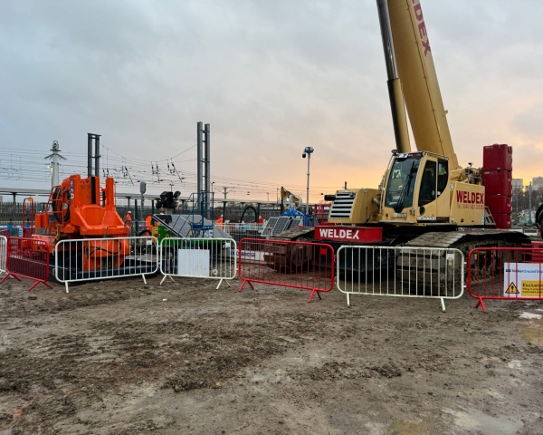Piling rig by a railway line at dusk