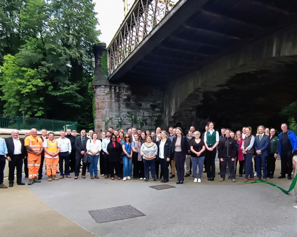 Group of people stood under a bridge