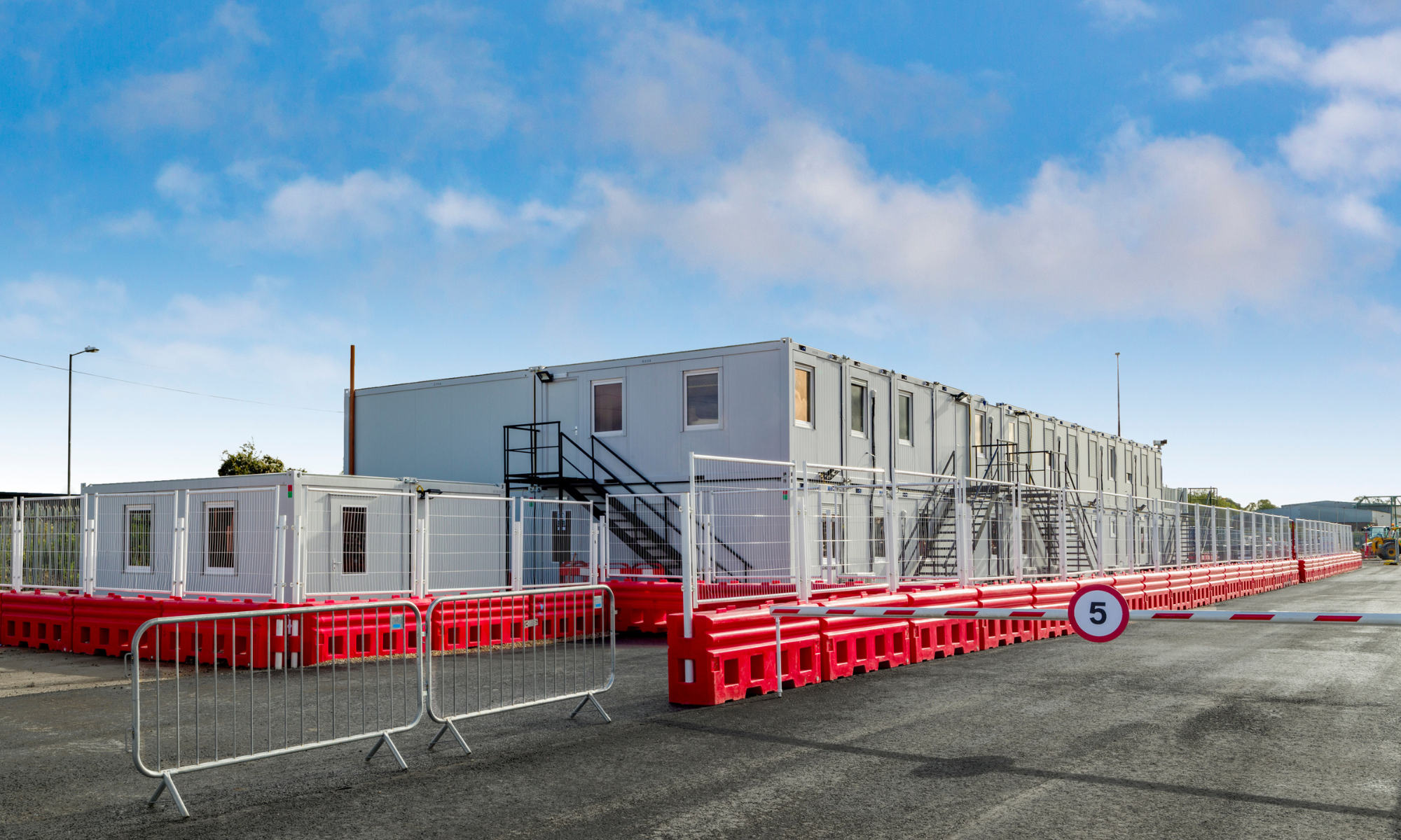 Photo showing the cabins, behind security gate, at Brent Cross