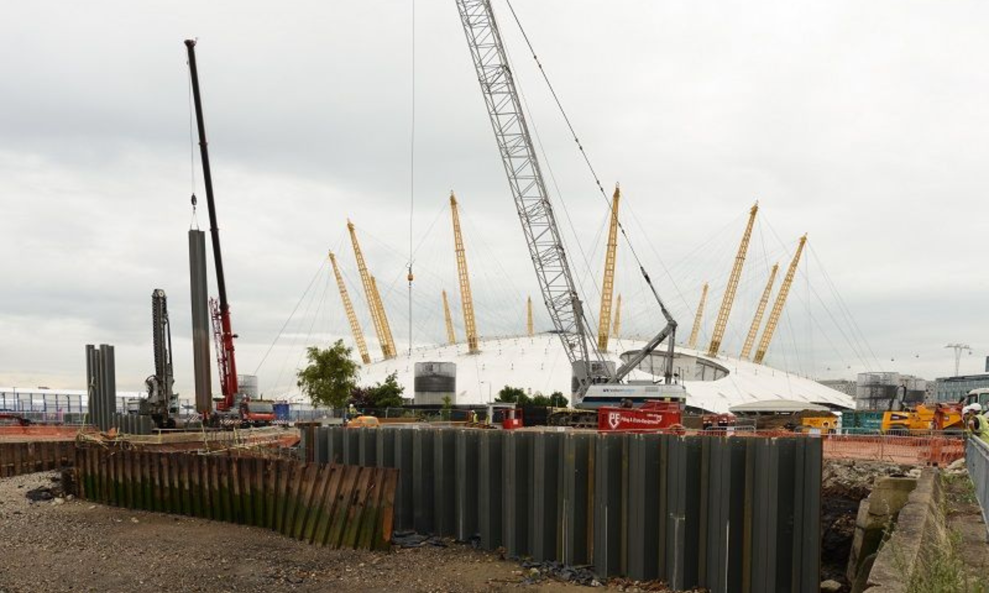 piling work on a construction site with O2 arena in the background