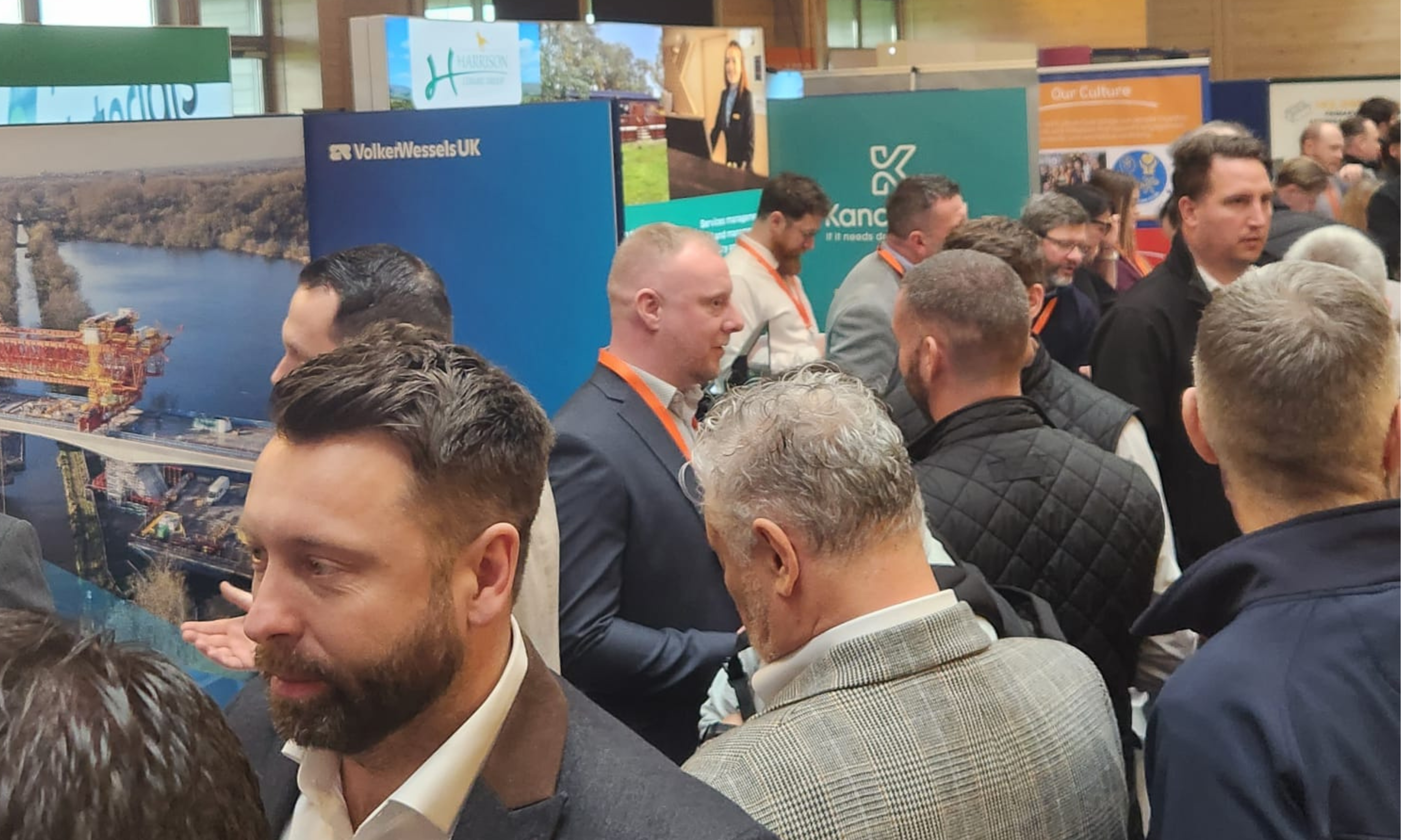 Group of people in an exhibition hall with exhibition stands